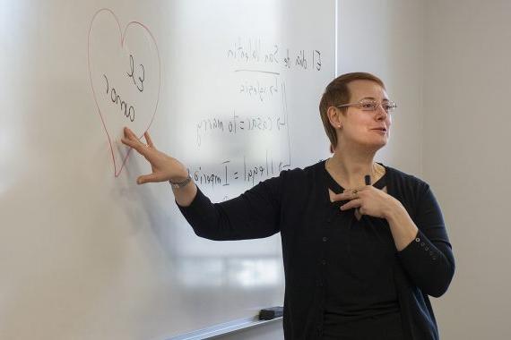 Ana Lopez-Aguilara teaching Spanish and pointing to a whiteboard